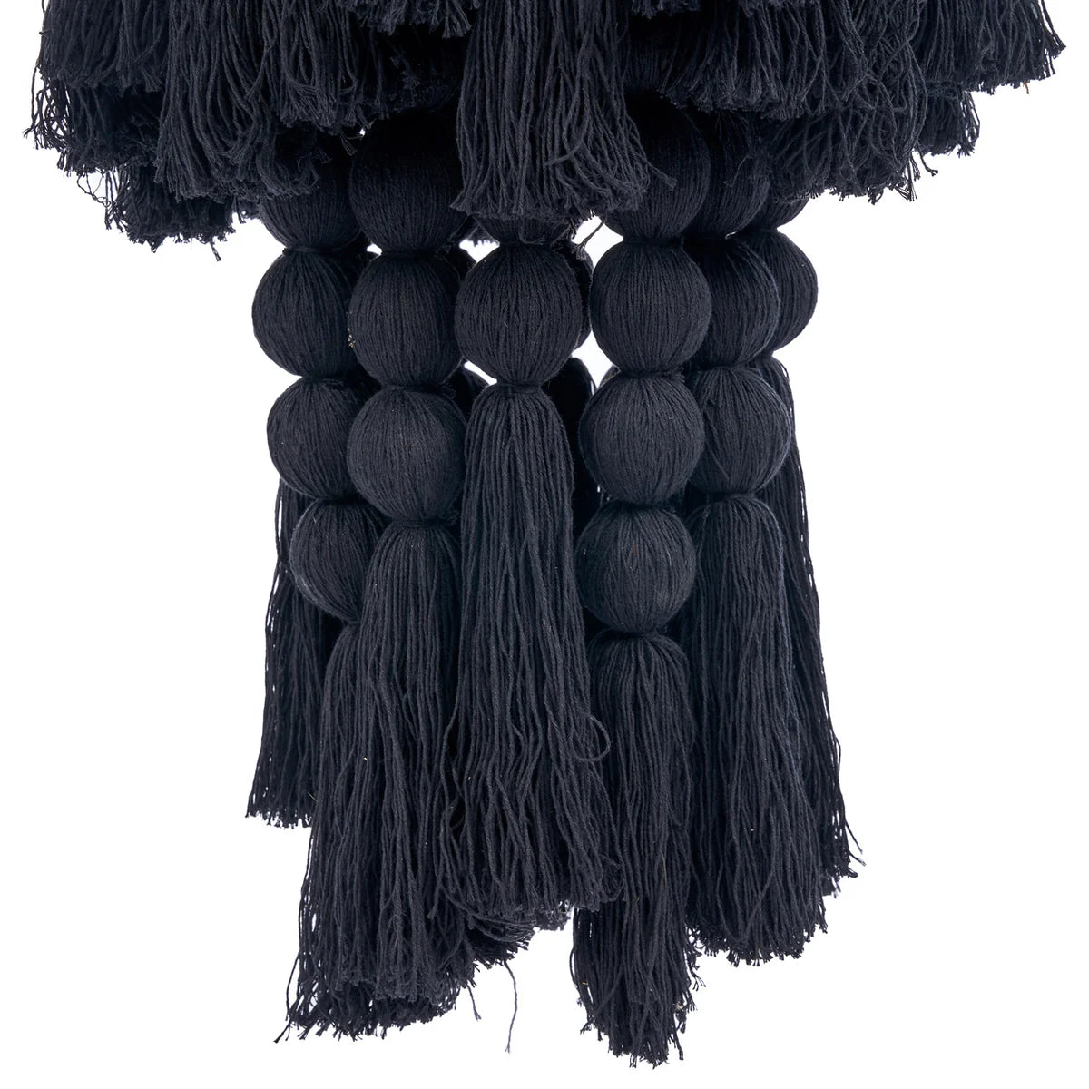 Black tassel and pom pom wall pendant light on a white background