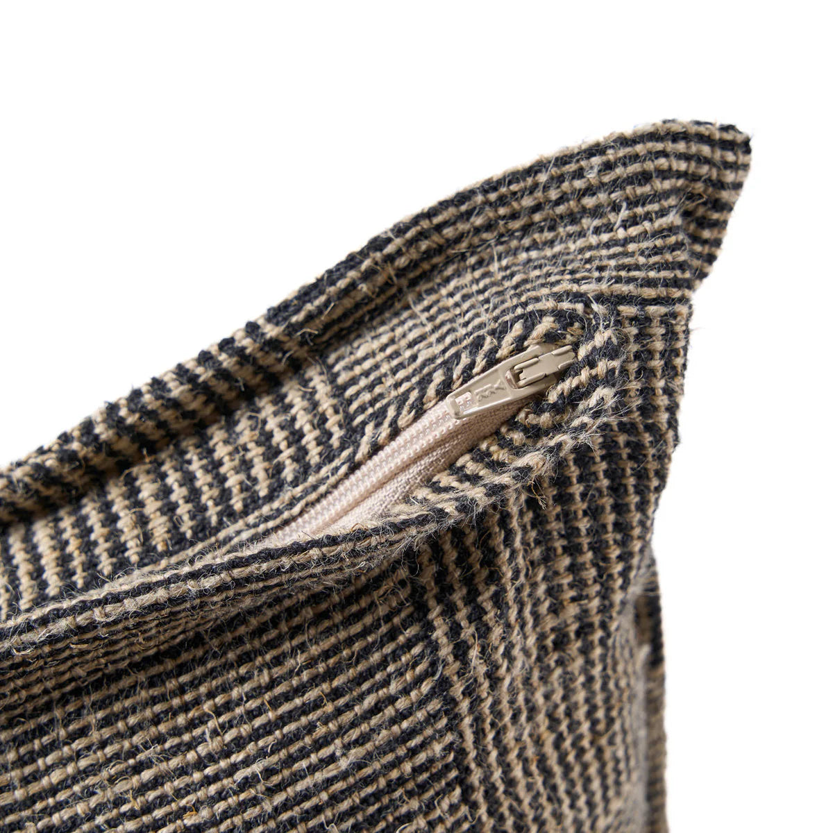 Close up of a textured fabric with a zipper on a white background