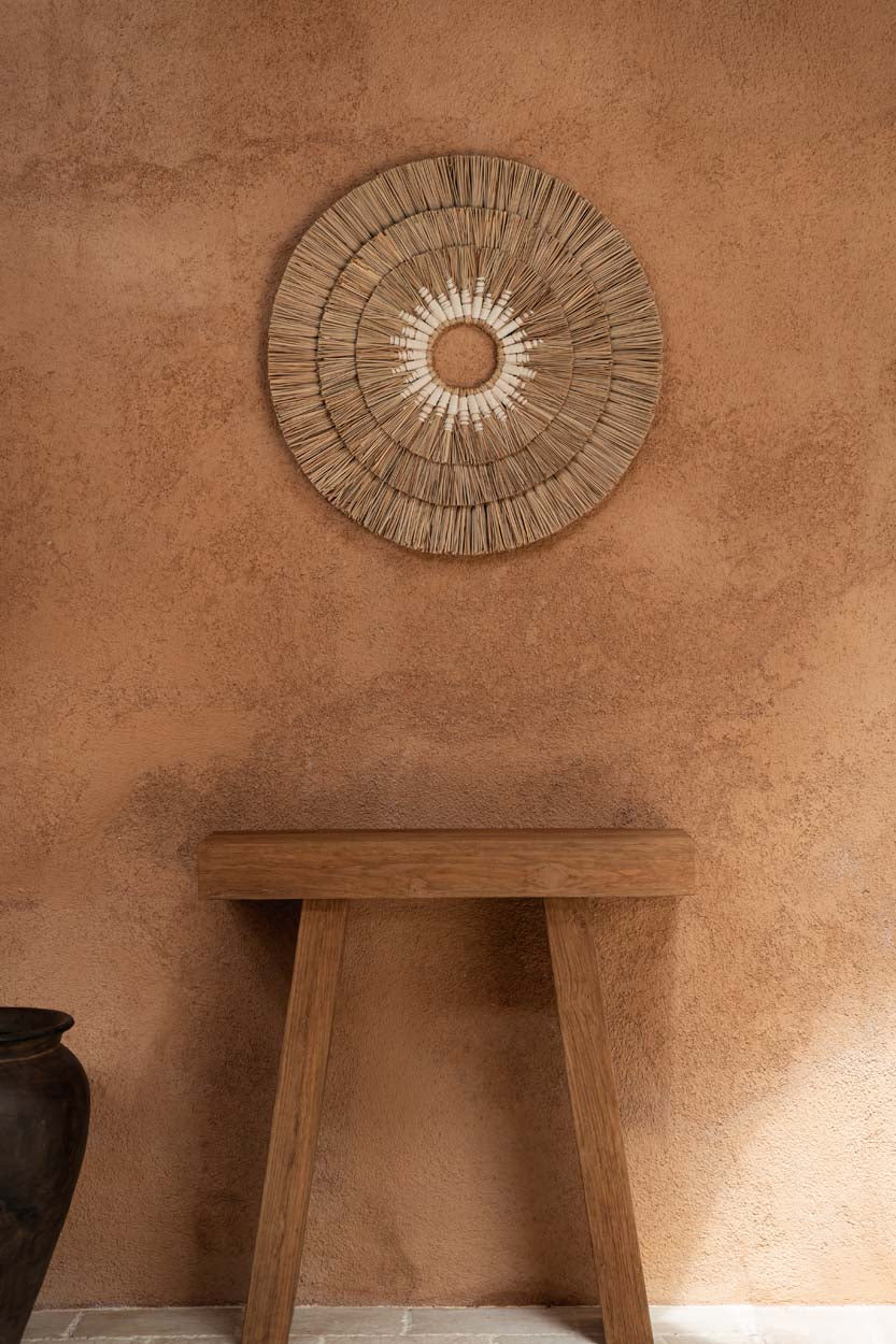 Teak wood console table in a terracotta lime wash plastered room flo & joe uk