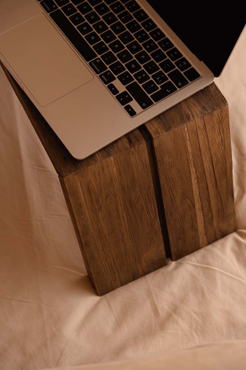 Laptop on a wooden bed or sofa table stand
