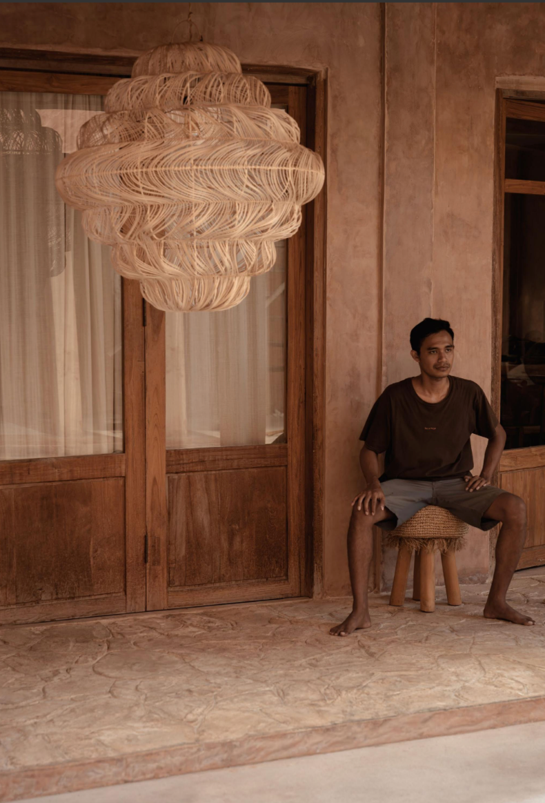 Extra large rattan chandelier hanging from ceiling in terracotta villa