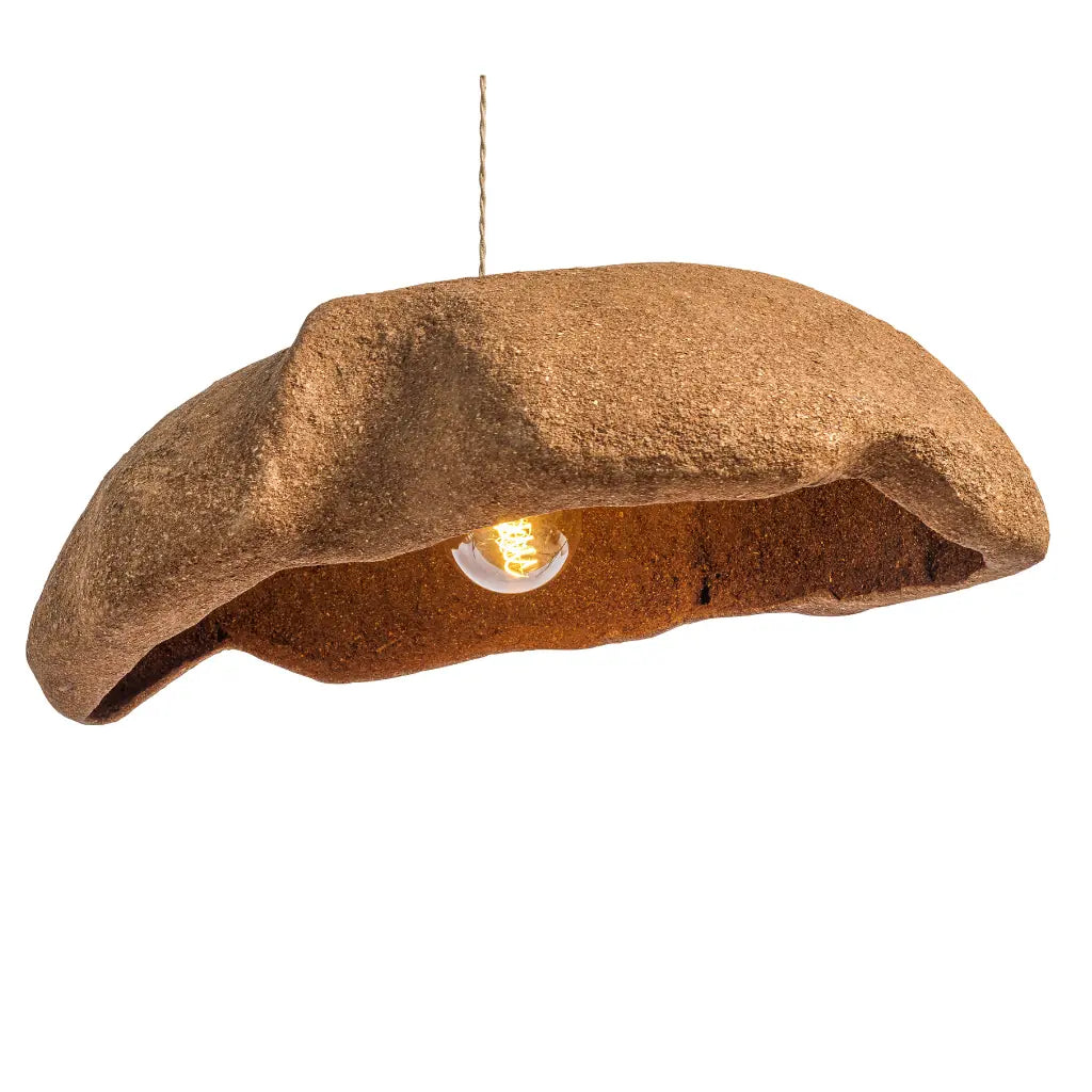 A unique pendant light shaped like a textured brown beret, with a warm glowing light bulb visible inside, suspended by a thin wire against a solid white background.