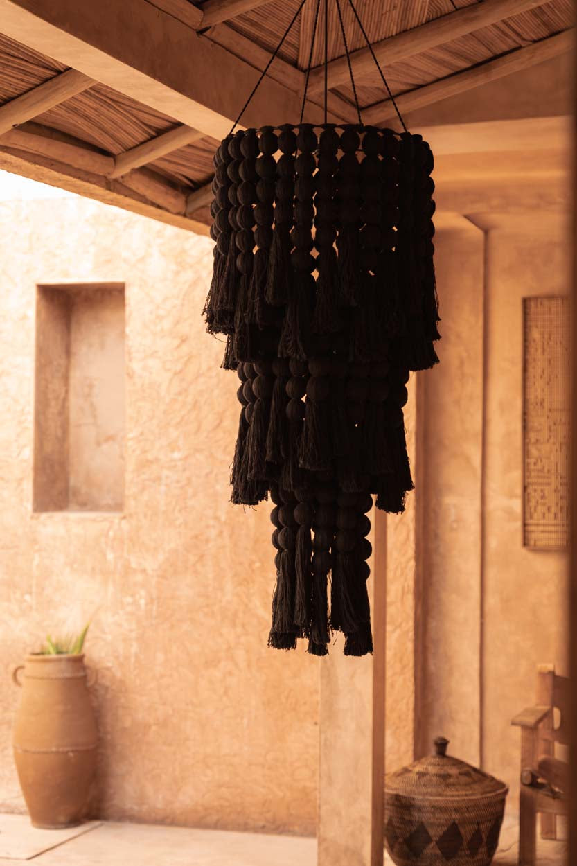 Black cotton tiered chandelier in rustic room