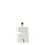 Artisanal shaped lamp with textured white surface on a white background