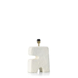 Artisanal shaped lamp with textured white surface on a white background