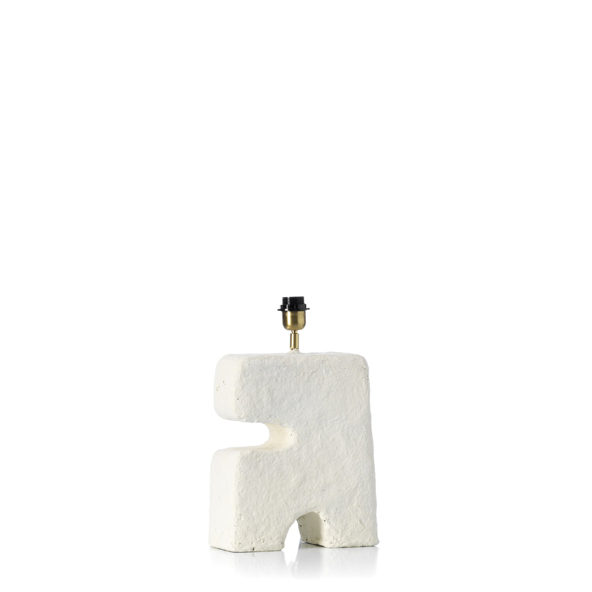Artisanal shaped lamp with textured white surface on a white background