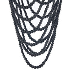 Multiple strands of black beaded chandelier pendant light on a white background