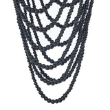 Multiple strands of black beaded chandelier pendant light on a white background