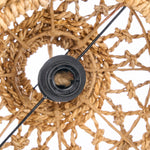 Close-up of a woven wreath with a black light bulb holder inside.