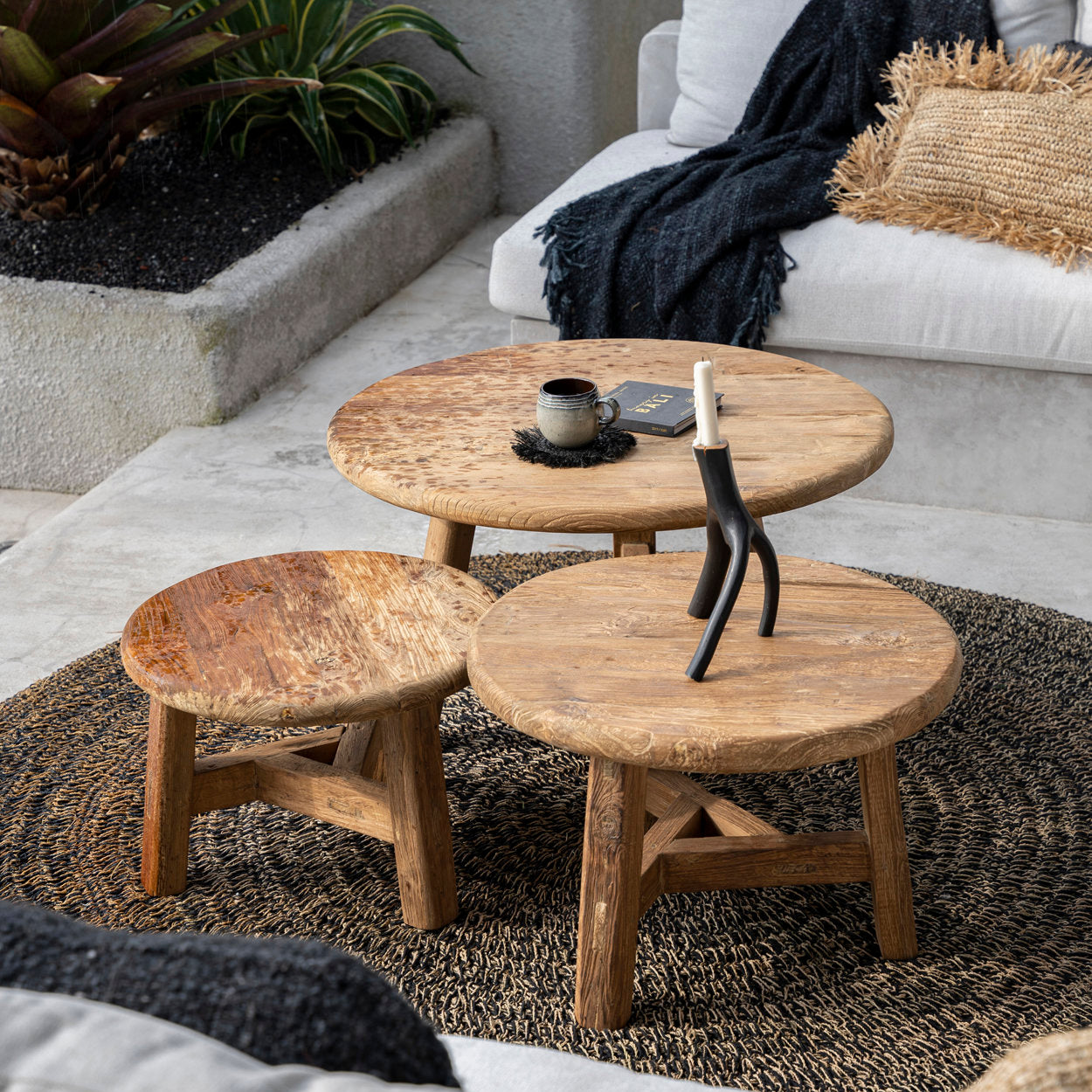 lounge seating area with wooden coffee tables and a white sofa.