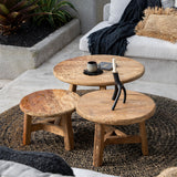 lounge seating area with wooden coffee tables and a white sofa.