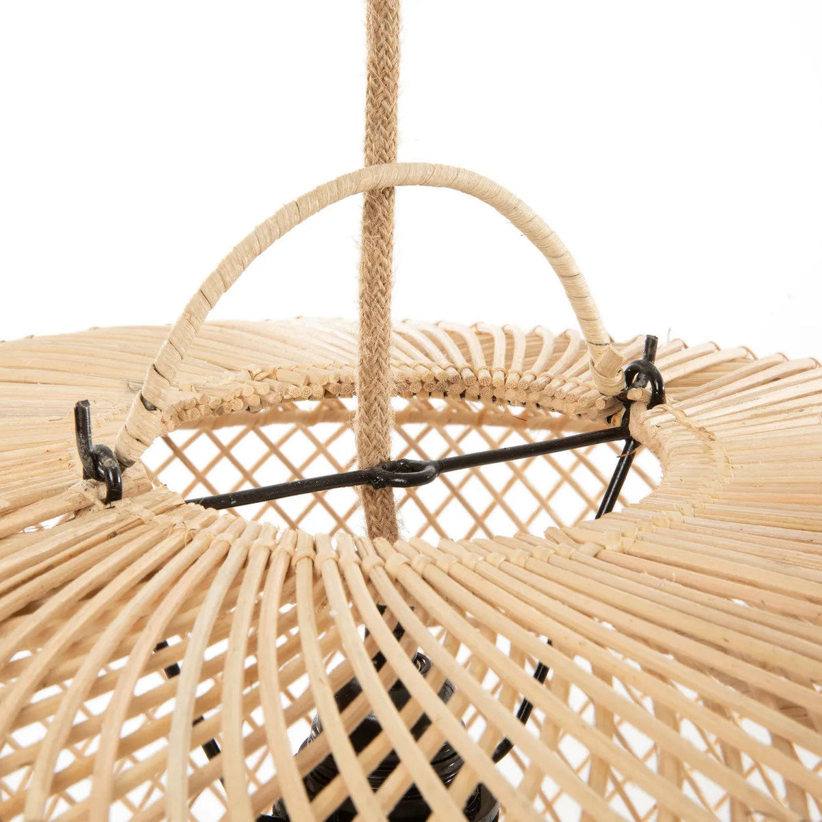 Close up of a woven rattan ceiling light fixture with black metal accents on a white background.