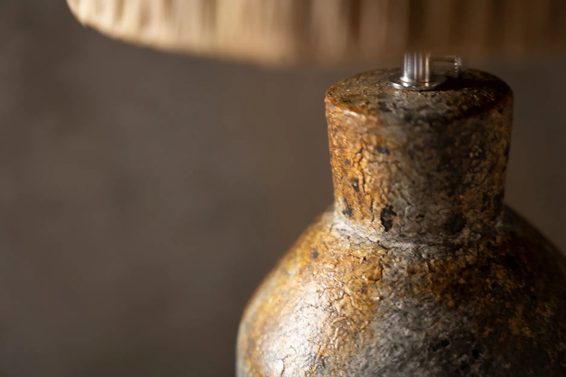 Close-up of a textured lamp base with a blurred background