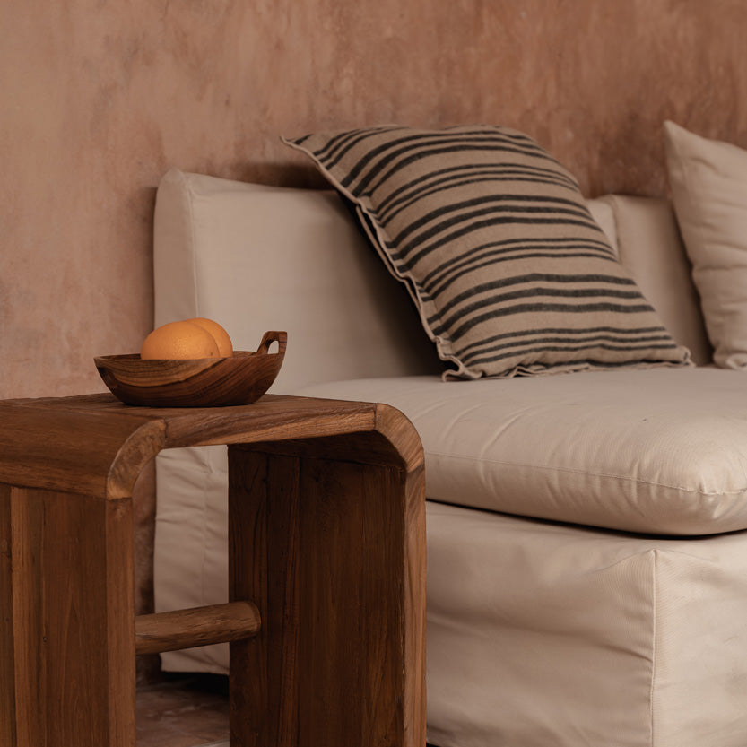 Teak Wood Side table in natural living room with plaster walls and linen sofa