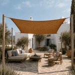 Outdoor patio with a sunshade canopy, furniture, and decorative elements on a sunny day.