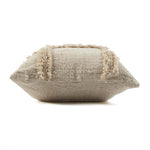 Textured beige pillow with decorative trim on a white background