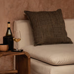 Teak Wood Side table in natural living room with plaster walls and linen sofa and dark cushions
