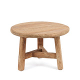 Round wooden coffee table with three legs on a white background