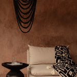 Black beaded chandelier in plastered modern rustic room 