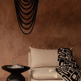 Black beaded chandelier in plastered modern rustic room 