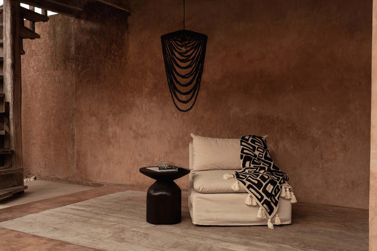 Black beaded chandelier in a wabi sabi warm living room