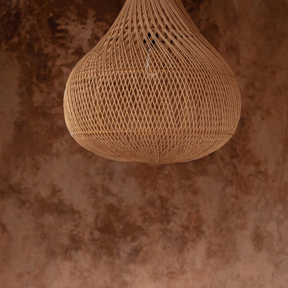 natural Woven rattan pendant light against a textured brown wall
