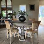 classic round wooden dining table with carved base, seats 4 and is 120cm in diameter