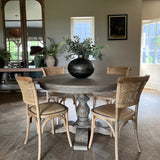 classic round wooden dining table with carved base, seats 4 and is 120cm in diameter