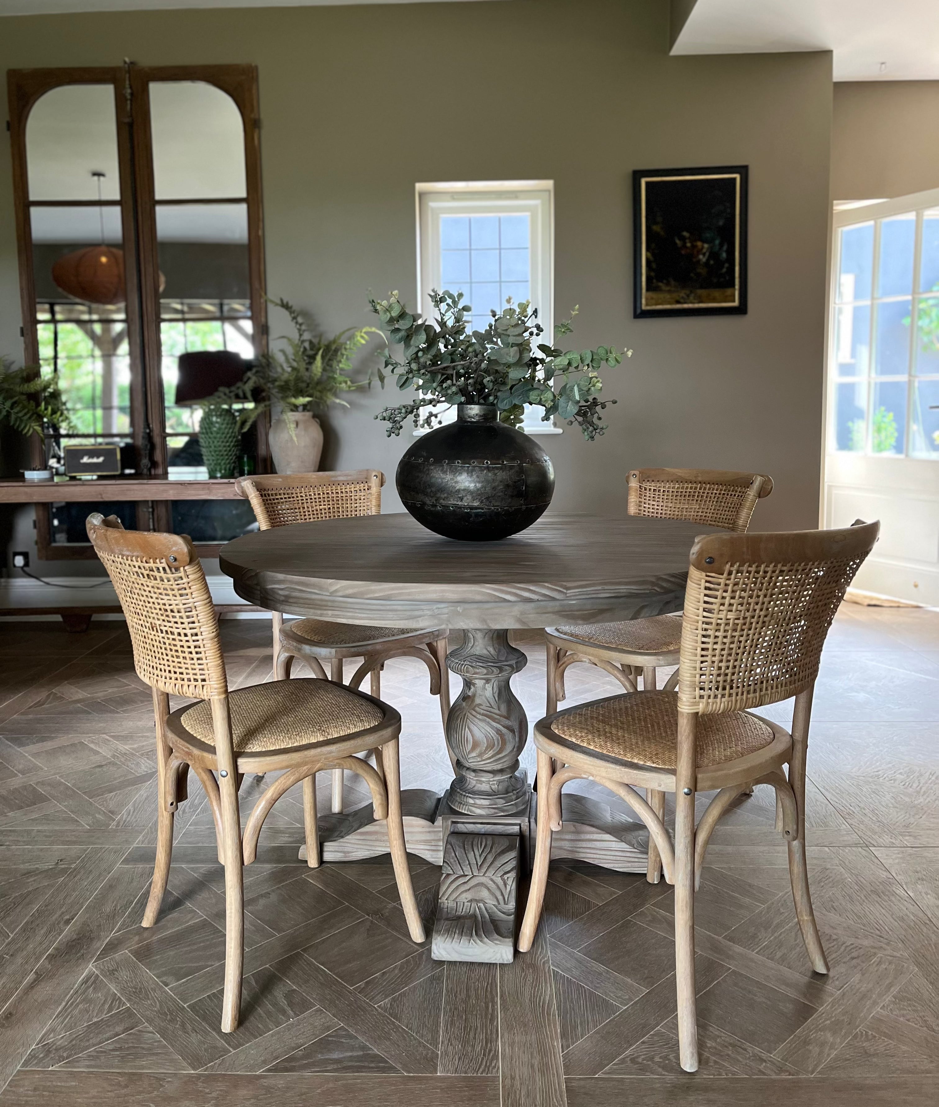 classic round wooden dining table with carved base, seats 4 and is 120cm in diameter