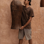 Dark Rattan Extra Large Pendant Ceiling Light being held 