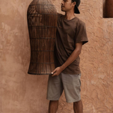 Dark Rattan Extra Large Pendant Ceiling Light being held 