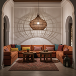 Rattan Pendant Light Shade in living room with orange sectional sofa, wooden coffee tables, and decorative pillows.
