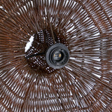 Close-up of a wicker rattan pendant light shade with a detailed pattern and central support structure.