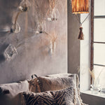 Long Raffia Pendant Light in a wabi sabi style bedroom