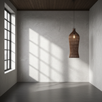 Large Rattan pendant light hanging in a room with sunlight casting shadows on the wall.