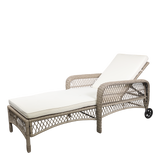 Wicker rattan  wheeled sun lounger chair with white cushion on a white background