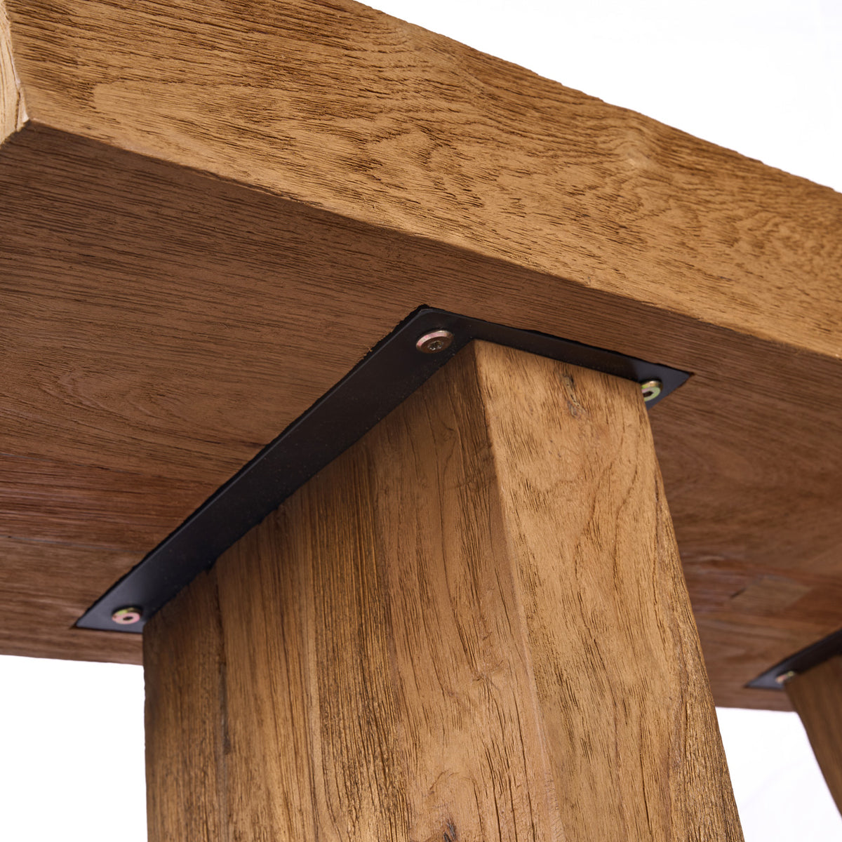 Close up of a teak wood console table with metal brackets on a white background