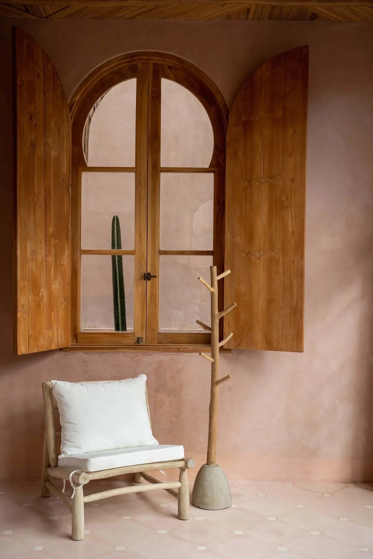 Tall wooden coat stand in hallway
