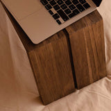 Laptop on a wooden bed or sofa table stand 