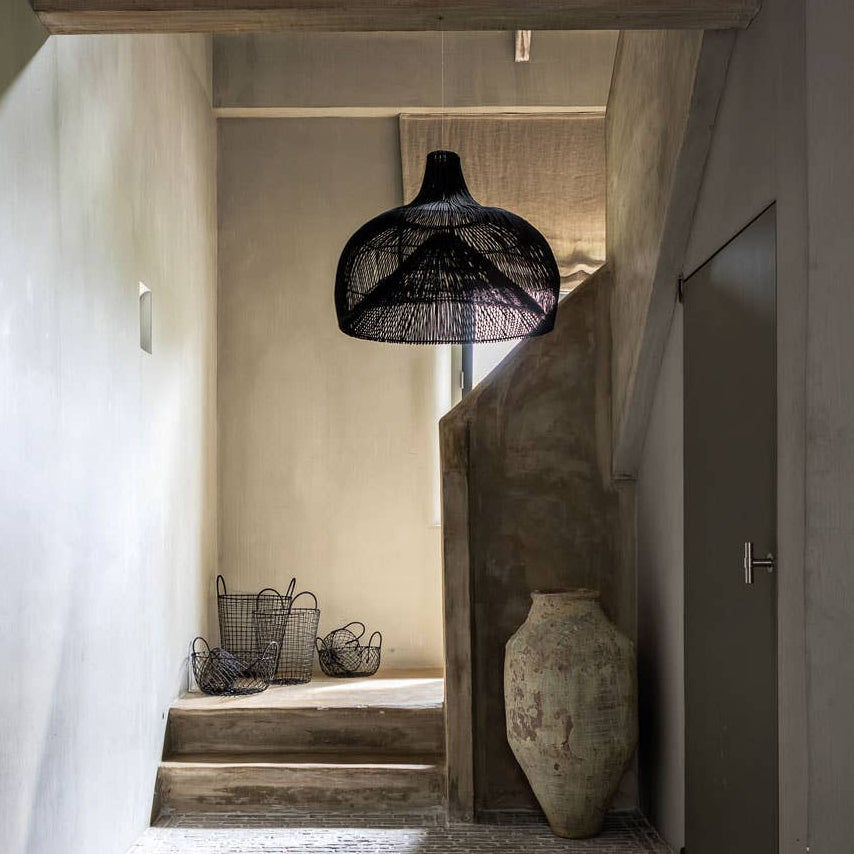 stairs in hallway with textured walls, a woven black rattan  pendant light.  Flo & Joe UK