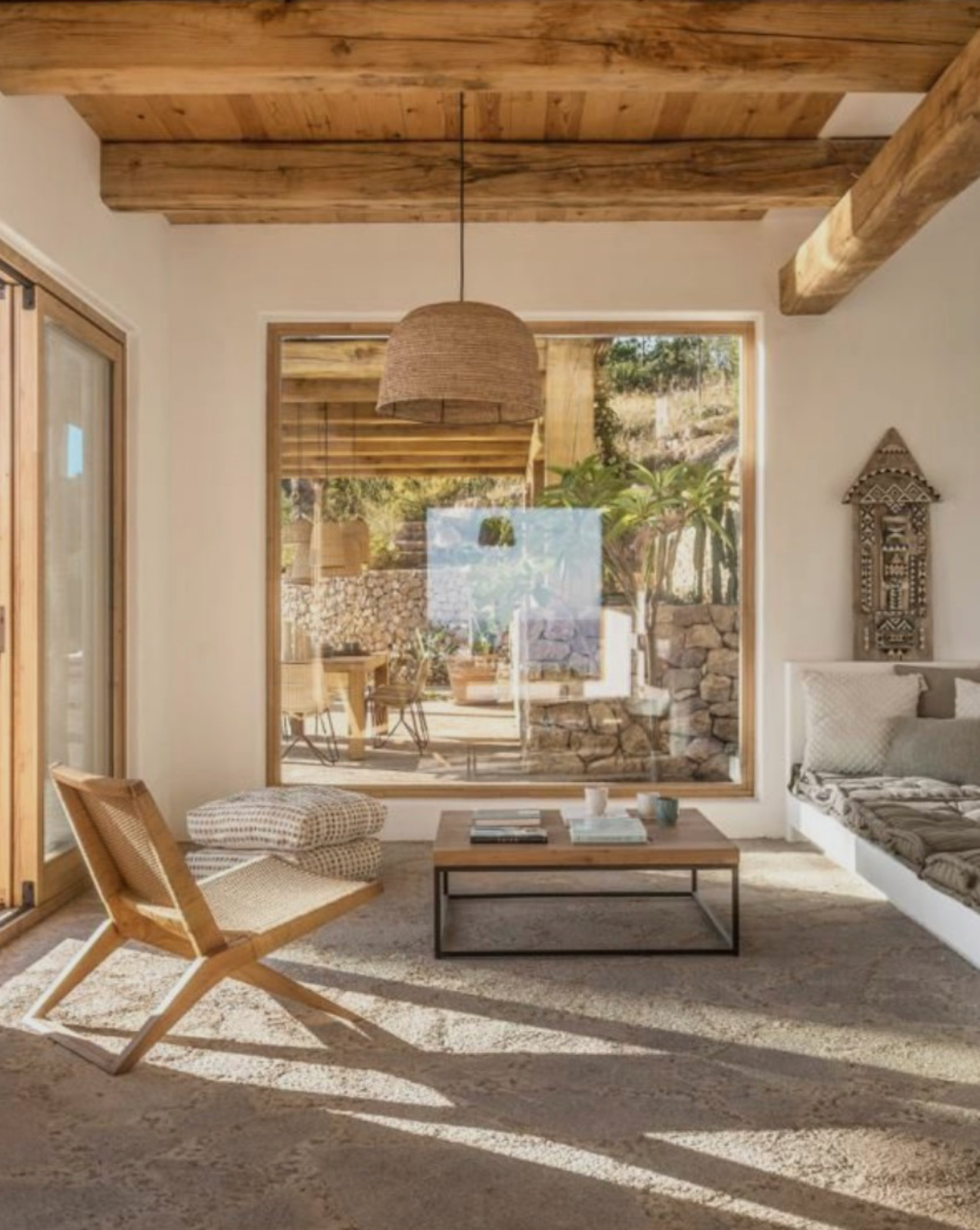 A large dome natural raffia rattan large light shade hanging in a living room - UK