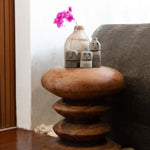 Rounded Tiered Wooden Stool used as a beside table.  Handmade UK Interior Design and supply