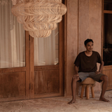 Extra Large Rattan Chandelier hanging from ceiling in terracotta villa
