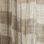 Close-up of a woven curtain panel with a textured basketweave pattern in beige and taupe tones.