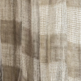 Close-up of a woven curtain panel with a textured basketweave pattern in beige and taupe tones.