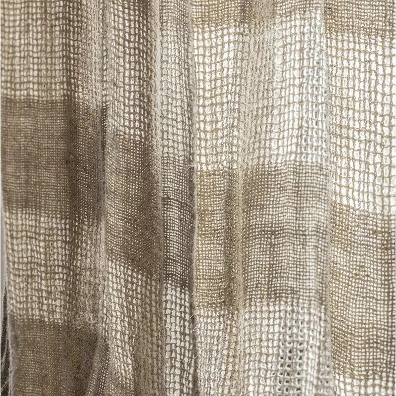 Close-up of a woven curtain panel with a textured basketweave pattern in beige and taupe tones.