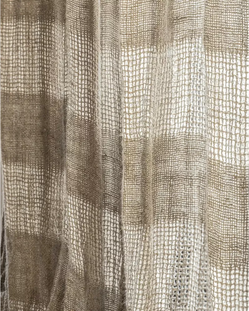 Close-up of a woven curtain panel with a textured basketweave pattern in beige and taupe tones.