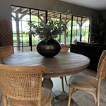 classic round wooden dining table with carved base, seats 4 and is 120cm in diameter