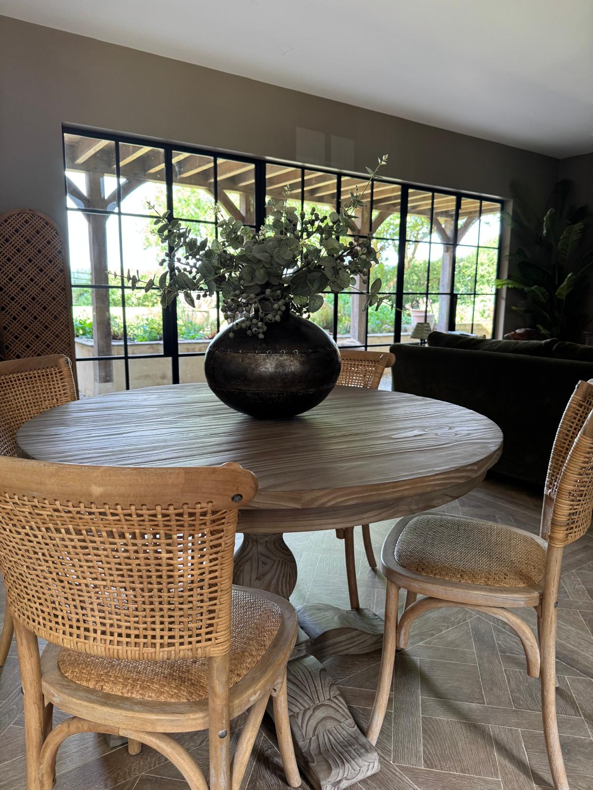 classic round wooden dining table with carved base, seats 4 and is 120cm in diameter