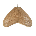 Woven pendant light with tassels hanging against a wooden wall.